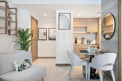 a living room with a table and chairs at Moon Stays - 5 PAX Missoni Flat - Canal View in Dubai