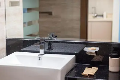 a bathroom with a sink and a mirror at Moon Stays - 5 PAX Missoni Flat - Canal View in Dubai