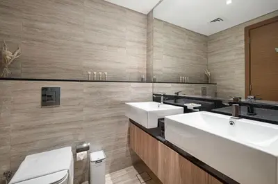 a bathroom with a white sink and a toilet at Moon Stays - 5 PAX Missoni Flat - Canal View in Dubai