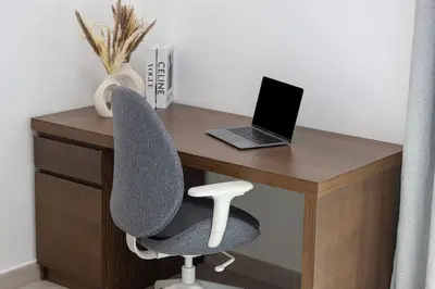 a desk with a laptop computer and a chair at StayMada - Lamtara Near Burj AlArab Beach Access in Dubai
