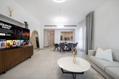 a living room with a couch and a table at StayMada - Lamtara Near Burj AlArab Beach Access in Dubai