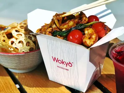 a container of food on a table with a bowl of food at Cosmos Living Majestic Studio GCV2 in Dubai