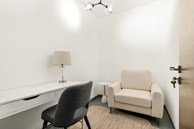 a white room with a desk and two chairs at VayK - Modern 2BR with Pool View in Sobha Hartland in Dubai