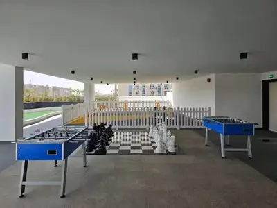 a room with two ping pong tables and a checkered floor at Vogue Al Furjan Pearlz by Danube near Ibn Battuta Mall, Three Bedroom plus Kids room Apartment with Balcony and Private pool, Access to all Amenities, Walkable to Al Furjan Metro Station in Dubai