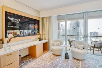 a waiting room with two chairs and a large window at PVH - Burj Khalifa View Studio - Emaar Residence Fashion Avenue in Dubai