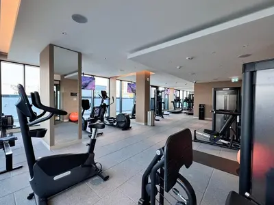 a gym with treadmills and exercise equipment in a building at Luxury 2BR in Sobha Hartland in Dubai