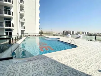 a swimming pool on the side of a building at Modern and Spacious 2BR in Glamz, Al Furjan in Dubai