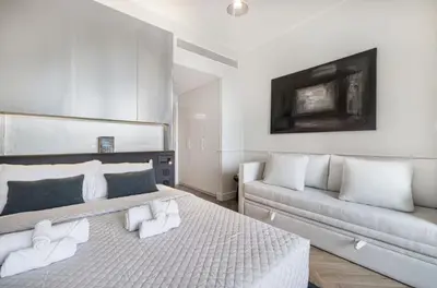 a bedroom with two beds and a couch at Premium Suite 3 BR 200 degree Views 85-inch TV and Sunset View in Dubai