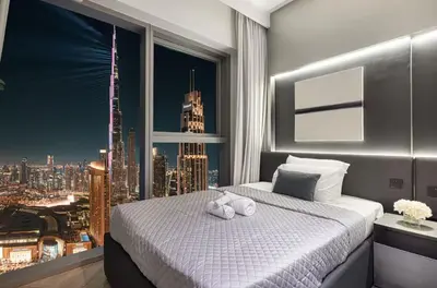 a bedroom with a large window with a city skyline at Premium Suite 3 BR 200 degree Views 85-inch TV and Sunset View in Dubai