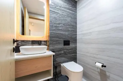 a bathroom with a sink and a mirror and a toilet at TRPS - Alef Noon, JVC - Brand New - Luxury Furnished 1BR - Prime JVC Location in Dubai