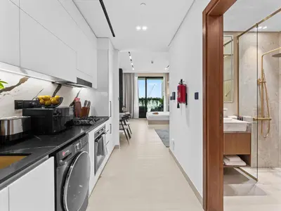 a kitchen with a sink and a dishwasher at BLVD - Stylish Stay with Private Jacuzzi and Canal View in Dubai