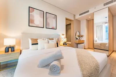 a bedroom with a large white bed with pillows at Luxury 1BR Stay, Connected to Dubai Mall and Burj Khalifa, Vida Dubai Mall Tower 2, Downtown Dubai by Deluxe Holiday Homes in Dubai