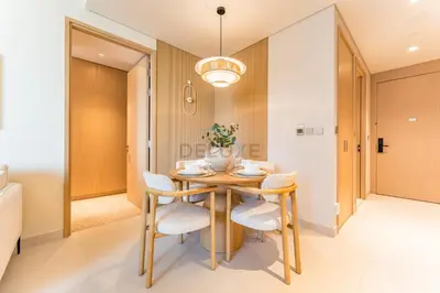 a dining room with a table and chairs at Luxury 1BR Stay, Connected to Dubai Mall and Burj Khalifa, Vida Dubai Mall Tower 2, Downtown Dubai by Deluxe Holiday Homes in Dubai