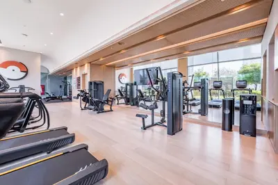 a gym with treadmills and elliptical machines at Luxury 1BR Stay, Connected to Dubai Mall and Burj Khalifa, Vida Dubai Mall Tower 2, Downtown Dubai by Deluxe Holiday Homes in Dubai