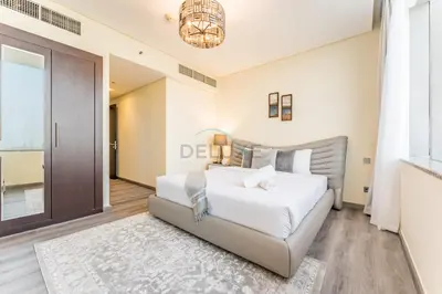a bedroom with a large white bed and a door at Close to Museum of the Future with Zaabeel Palace Views, Minutes from Dubai Mall And Burj Khalifa - Sky Gardens, DIFC by Deluxe Holiday Homes in Dubai