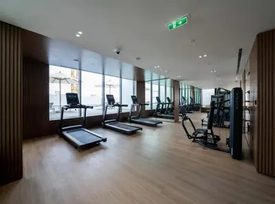 a gym with a row of treadmills and machines at Studio JVC I Fully Furnished I Epic Pool in Dubai