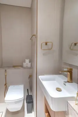 a bathroom with a white sink and a toilet at Studio JVC I Fully Furnished I Epic Pool in Dubai