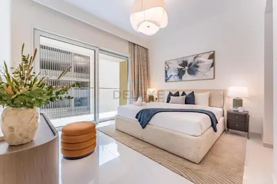 a bedroom with a large bed and a large window at Partial Sea Views with Private Beach Access, Near Dubai Marina and Palm Jumeirah, Grand Bleu Tower by Elie Saab, Tower 2, Emaar Beachfront by Deluxe Holiday Homes in Dubai