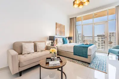 a living room with a bed and a couch at Studio Overlooking the Pool, Close to Parks, Grocery Stores, and Circle Mall, Damac Ghalia, JVC by Deluxe Holiday Homes in Dubai