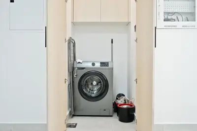 a laundry room with a washer and dryer at Stylish 1BR Retreat Huge Balcony in Dubai