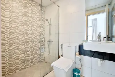a bathroom with a toilet and a sink and a shower at Stylish 1BR Retreat Huge Balcony in Dubai