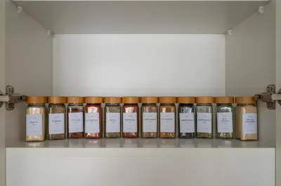 a row of bottles of spices on a shelf at Beach Please in Dubai