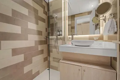 a bathroom with a sink and a mirror at Seven Palm Studio Roof Top Pool Beach Gym for free in Dubai