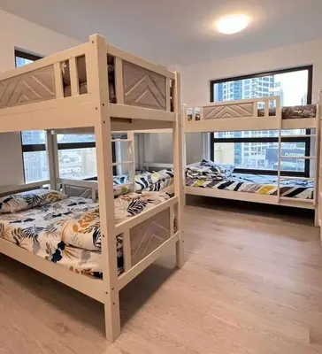 a room with three bunk beds in a building at Expedite Homes in Dubai