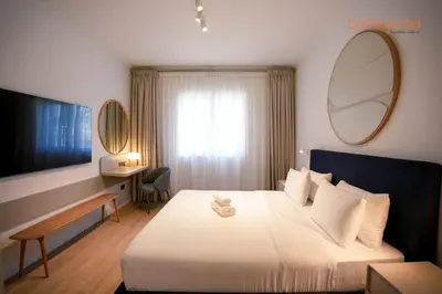 a hotel room with a bed and a mirror at Bnbeyond Ultra-Luxe 2BR with Burj Khalifa Panorama in Dubai