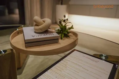 a room with a table with a book and a sign at Bnbeyond Ultra-Luxe 2BR with Burj Khalifa Panorama in Dubai