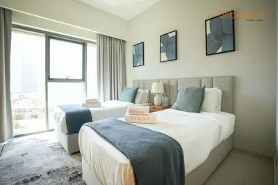 a hotel room with two beds and a window at Burj Khalifa Light Show from your Bed in Dubai