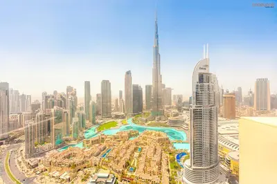 an aerial view of a city with tall buildings at Burj Khalifa Light Show from your Bed in Dubai