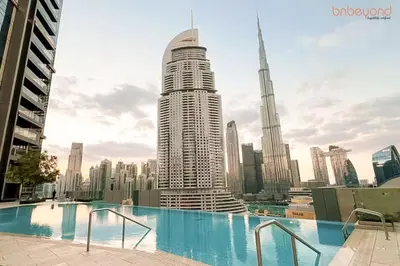 a view of a large building in a city at Burj Khalifa Light Show from your Bed in Dubai