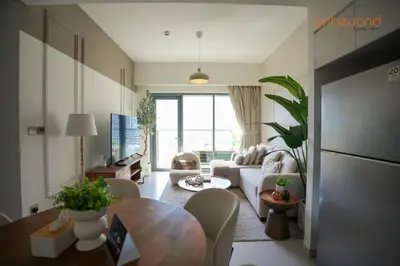 a living room with a couch and a table at Burj Khalifa Light Show from your Bed in Dubai