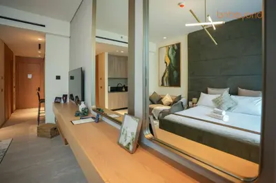 a bedroom with a large bed and a mirror at Signature Stay at The Autograph in Dubai