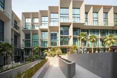 an exterior view of a building with palm trees at Signature Stay at The Autograph in Dubai