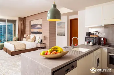 a kitchen with a bowl of fruit on a counter at Dubai Mall Apartments by Suitestay in Dubai