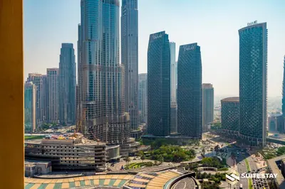 a group of tall buildings in a city at Dubai Mall Apartments by Suitestay in Dubai