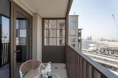 a balcony with a table and a view of the city at GuestReady - 1Bed l Lagoon Escape l Creek Beach in Dubai