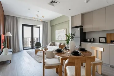 a kitchen and living room with a table and chairs at GuestReady - 1Bed l Lagoon Escape l Creek Beach in Dubai