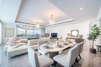 a dining room with a table and chairs at Marina Luxury 5 Bedroom & Private Pool in Dubai