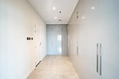 an empty hallway with white walls and a tile floor at Marina Luxury 5 Bedroom & Private Pool in Dubai