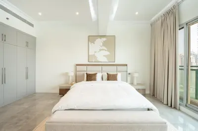 a white bedroom with a large bed and large windows at Marina Luxury 5 Bedroom & Private Pool in Dubai