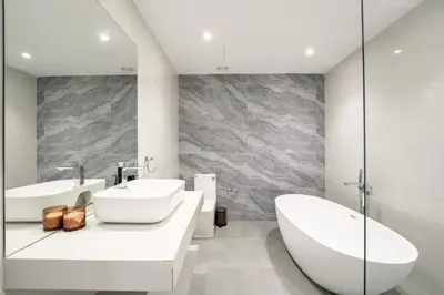 a white bathroom with two sinks and a tub at Marina Luxury 5 Bedroom & Private Pool in Dubai