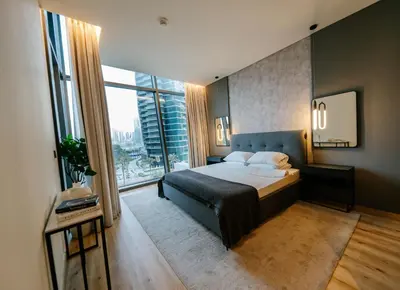 a bedroom with a bed and a large window at Full Burj Khalifa Views at Burj Vista in Dubai