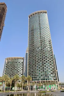 two tall buildings with palm trees in front of them at Full Burj Khalifa Views at Burj Vista in Dubai