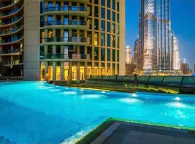 a large swimming pool in front of a tall building at Full Burj Khalifa Views at Burj Vista in Dubai