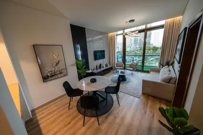 a living room with a table and chairs at Full Burj Khalifa Views at Burj Vista in Dubai