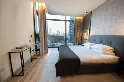 a bedroom with a large bed and a large window at Full Burj Khalifa Views at Burj Vista in Dubai