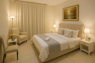 a bedroom with a large bed and a chair at 1 Bhk Huge Apartment In Heart of Dubai Marina in Dubai